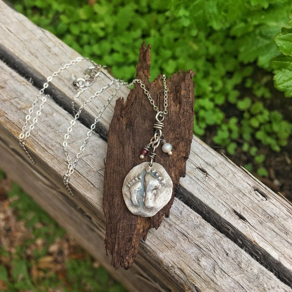 silver locket with foot imprint